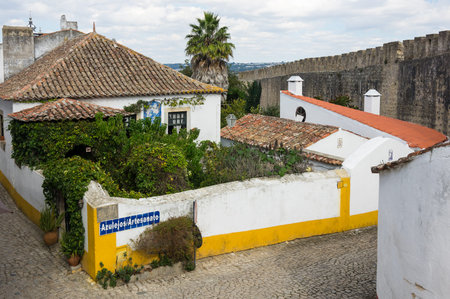 OBIDOS, PORTUGAL - OCTOBER 15, 2015: The street of Obidos in Portugal, popular tourist destination because of its a well-preserved medieval architectureのeditorial素材
