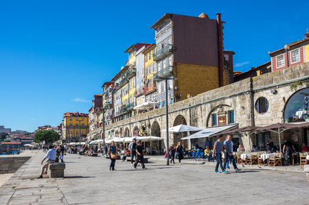 PORTO, PORTUGAL - OCTOBER 21, 2015: Tourists walking on the street of the old town of Porto, the...