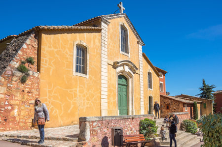 ROUSSILLON, FRANCE - APRIL 27, 2016: Street of medieval village of Roussillon. It ochre village is...