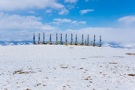 Wooden ritual pillars with colorful ribbons on cape Burkhan, Lake Baikal, Olkhon Island, Siberia, Russiaの写真素材