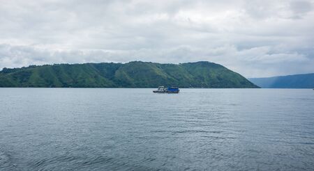 Lake Toba is a large natural lake occupying the caldera of a supervolcano, located in the middle of the northern part of the Indonesian island of Sumatraの写真素材