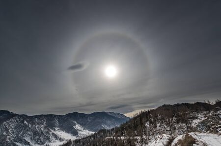 View of a sun halo overAltay mountains in the winter, Siberia, Russiaの写真素材