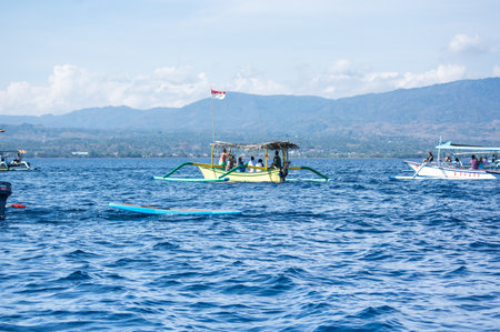 BALI, INDONESIA - 16 SEPTEMBER 2018: Tourists looking for dolphins from boats at Lovina beach of Bali, Indonesia. Popular activities for visitors include early-morning boat trips to see dolphinsのeditorial素材