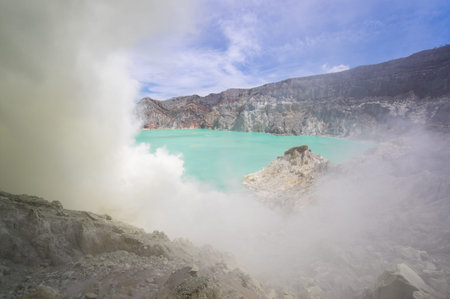 Ijen volcano with turquoise-colored acidic crater lake in East Java, Indonesia