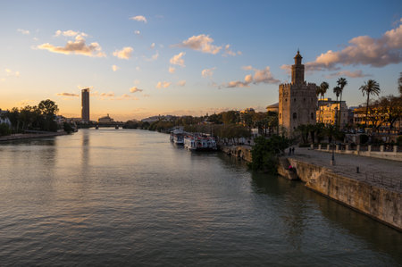 SEVILLE, SPAIN - 06 APRIL, 2019: View of Guadalkivir river and Torre del Oro, historical limestone Tower of Gold in Seville, a big tourist center in Spainのeditorial素材