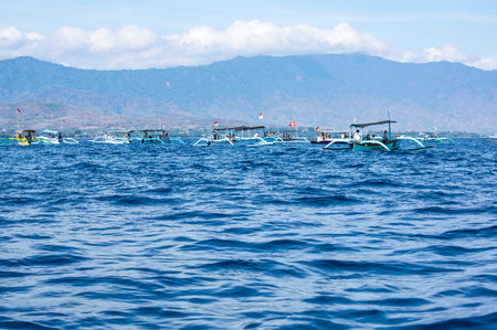 BALI, INDONESIA - 16 SEPTEMBER 2018: Tourists looking for dolphins from boats at Lovina beach of Bali, Indonesia. Popular activities for visitors include early-morning boat trips to see dolphinsのeditorial素材