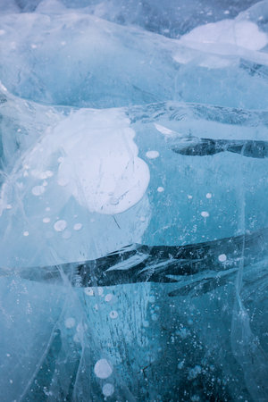 Gas methane bubbles frozen in blue ice of lake Baikal, Siberia, Russiaの写真素材