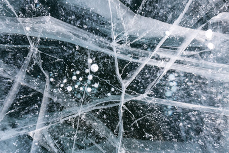 Gas methane bubbles frozen in blue ice of lake Baikal, Siberia, Russiaの写真素材