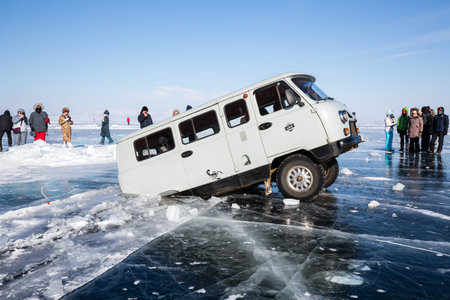 BAIKAL, RUSSIA - FEBRUARY 15, 2021: View of a car falling into a crack at Baikal lake, Siberia, Russiaのeditorial素材