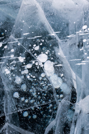 Gas methane bubbles frozen in blue ice of lake Baikal, Siberia, Russiaの写真素材