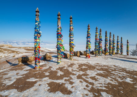 Wooden ritual pillars with colorful ribbons on cape Burkhan, Lake Baikal, Olkhon Island, Siberia, Russiaの写真素材
