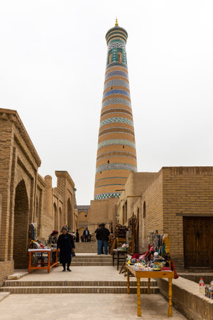 KHIVA, UZBEKISTAN - APRIL 05, 2022: Islam Khodja Minaret and Madrasah in the Itchan Kala, the historic old town of Khiva in Uzbekistanのeditorial素材