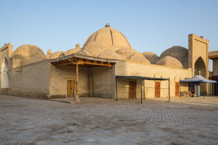 BUKHARA, UZBEKISTAN - APRIL 12, 2022: Old houses in historic center of Bukhara, Uzbekistan. Bukhara is a popular tourist attraction of Central Asiaのeditorial素材