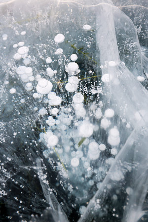 Gas methane bubbles frozen in blue ice of lake Baikal, Siberia, Russia