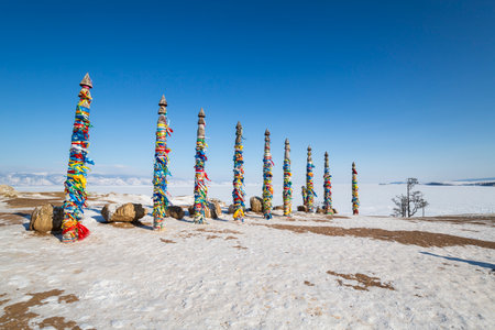 Wooden ritual pillars with colorful ribbons on cape Burkhan, Lake Baikal, Olkhon Island, Siberia, Russiaの写真素材