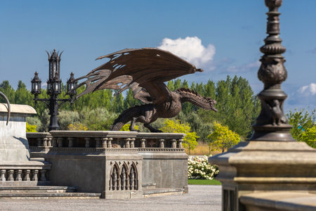 Stone monument pedestal with bronze dragon statue in Garibaldi Castle complex at sunny day, Samara region, Russia. A popular tourist attraction at summer travel vacationsの写真素材
