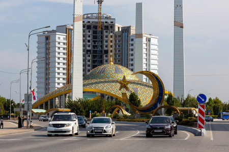 ARGUN, CHECHEN REPUBLIC, RUSSIA - SEPTEMBER 23, 2023: Cityscape of city Argun with car traffic, road and Aimani Kadyrova Mosque "Mother's Heart", first mosque in Russia in an ultra-modern styleのeditorial素材