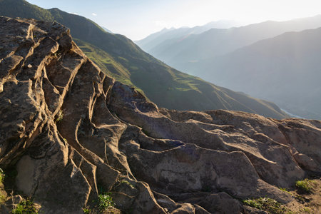 Scenery of mountainside and mountain ridges, hidden by a light haze. Travel in North Caucasus, the...