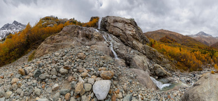 Panorama of steep cliff and Alibek Waterfall, one of the most powerful and high cascade in Dombay, Teberda Nature Reserve, North Caucasus mountains. Formed by the fall of the Dzhalovchatka Riverの写真素材