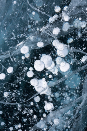 Gas methane bubbles frozen in blue ice of lake Baikal, Siberia, Russia