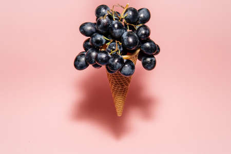 Ice cream cone filled with fresh grapesの写真素材