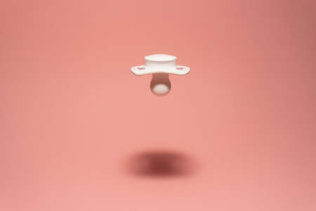 White baby pacifier in the airの写真素材