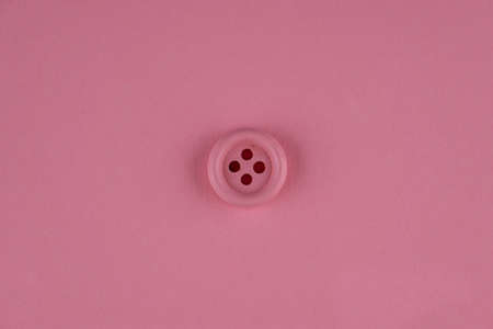 Minimal pink background with pink button in middle. Flat layの写真素材