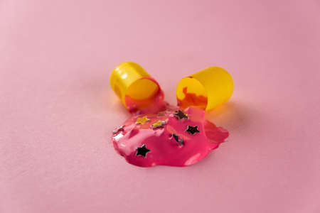 Creative layout of open pill with dripping paint with stars. Macro shotの写真素材