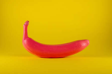 Pink banana on yellow background. Minimal food conceptの写真素材
