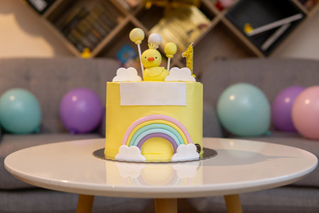 First birthday cake with little chicken and rainbow. White copy space on frontの写真素材