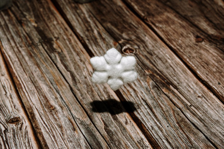 Snowflake flying over wooden floor. Minimal winter conceptの写真素材