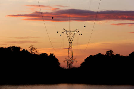 Silhouette high voltage post, power transmission tower at Sirindhorn Dam in the morning timeの写真素材