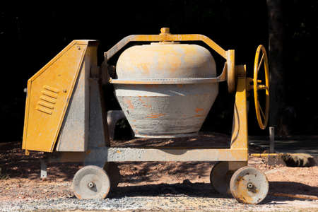 Industrial cement mixer machine at construction site.の写真素材