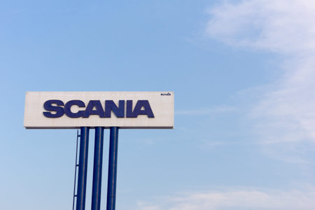 Bangkok, Thailand - November 12, 2014 : Sign Scania against blue sky. Founded in 1891 in Sodertalje, Sweden, Scania is one of the worldâs leading manufacturers of heavy trucks, buses, industrial and marine engines.のeditorial素材