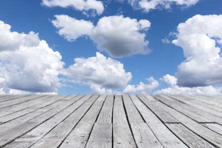 wooden planks walkway and cloudy blue sky backgroundの写真素材