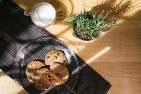 chocolate chip cookie and almond cookie with milk in the morningの写真素材