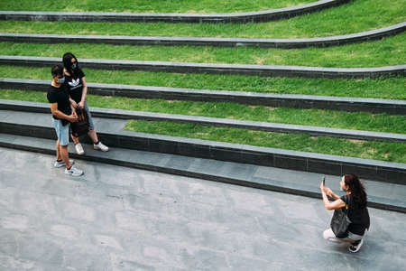 Bangkok, Thailand - June 30, 2020 : asian travelers wearing hygiene face mask to protect from coronavirus pandemic or covid-19 virus outbreak are traveling and taking photo at park or shopping centerのeditorial素材