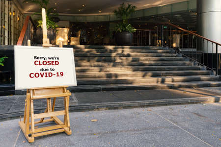 restaurant, hotel, company, shopping center closed due to coronavirus or covid-19 pandemic outbreak lockdown. coronavirus news temporarily closed board in front of building after government shutdownの写真素材