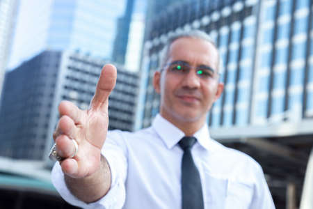 success businessman professional making handshake in front of office building at business center in the city after giving opportunity to new partner. business and partnership concept. selective focusの写真素材