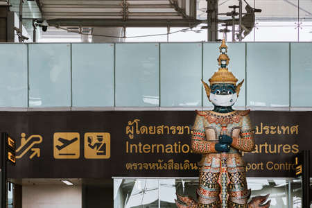 Bangkok, Thailand - September 19, 2021 : thai traditional giant statue at Suvarnabhumi airport wears protective face mask  to encourage mask wearing to prevent infection.のeditorial素材