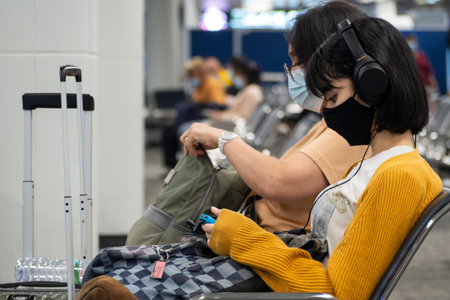 Bangkok, Thailand - May 18, 2021 : young asian woman teenager wearing protective face mask for...