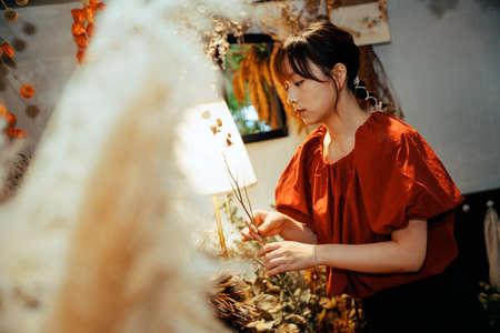 A happy girl exploring in a flower shop.の写真素材