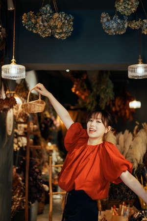 A girl exploring happily in a flower shopの写真素材