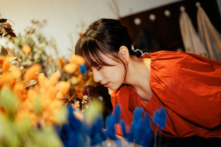 A girl exploring happily in a flower shopの写真素材