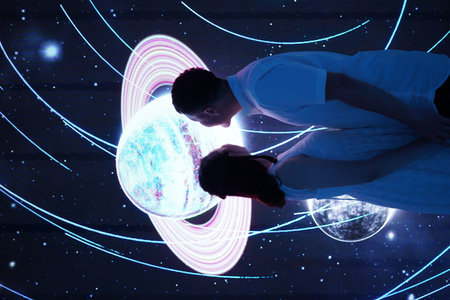 Image of young man and woman looking at planet in space. Space concept
