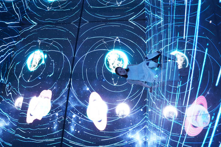 Astronaut flying in space with glowing planets in the night sky
