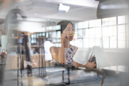 Portrait of young businesswoman sitting at her desk in the office