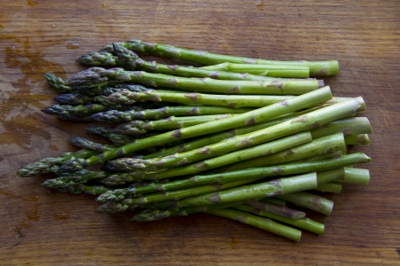 Food ingredients  green asparagus on wooden kitchen boardの写真素材