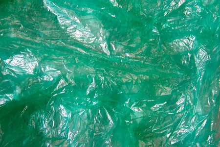 Abstract background from green plastic bag closeup