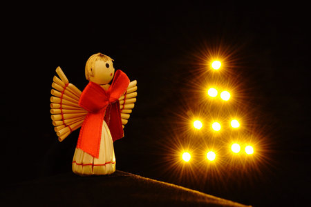 Little straw angel with shiny star treeの写真素材